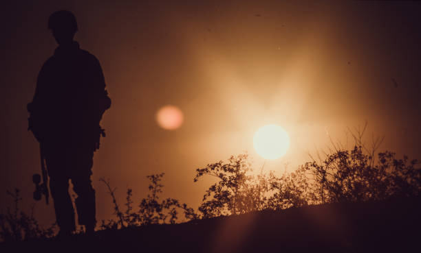 istock Longboarder silhouetted in sunset stock photo 1170775390