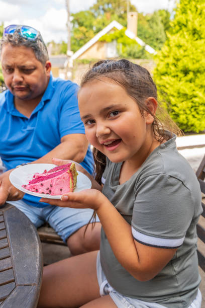 istock Eleven year old girl holding cake slice 1170778726