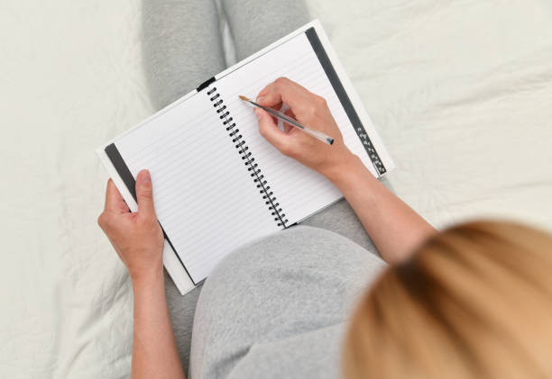 istock Pregnant woman taking notes in a notebook 1170779722