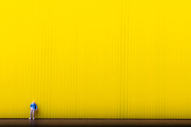 Miniature traveler people standing on yellow background with copy space, Concept of minimal.
