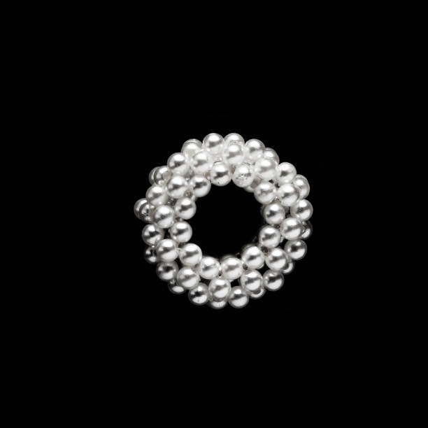 istock ring pearl bracelet on a black background 1170784288