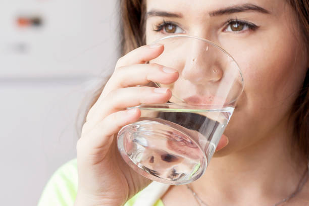 istock woman drinking water 1170788704