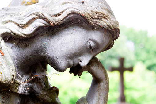 Old statue of angle in cemetery build in 1850 Czech Republic, background with copy space, full frame horizontal composition