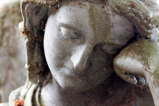 istock Closeup old statue of sleeping angle in cemetery, background with copy space 1170792252