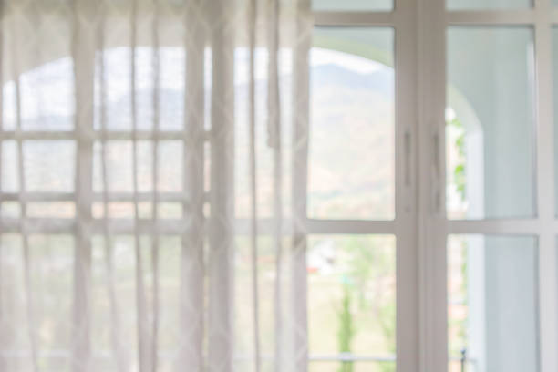 istock window curtain with green garden abstract blur background 1170793132