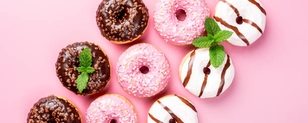 istock Colorful donuts on rose background 1170795551