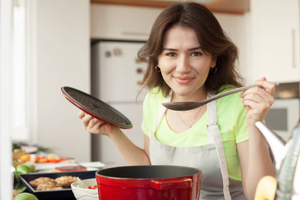 istock young woman cooking at domestic kitchen 1170795632