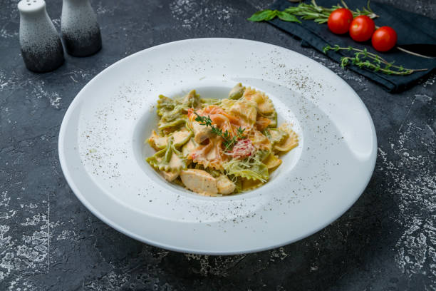 istock Farfalle with chicken on dark grey concrete table 1170797251