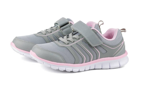 istock Gray with pink children's sneakers isolated on white background. 1170800796