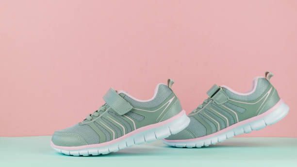 istock Walking women's sneakers on pink and blue background. 1170800818
