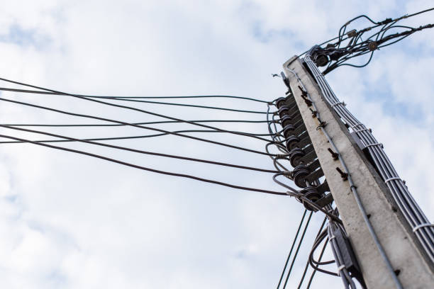 istock Power poles and power lines on the sky and clouds background 1170802302