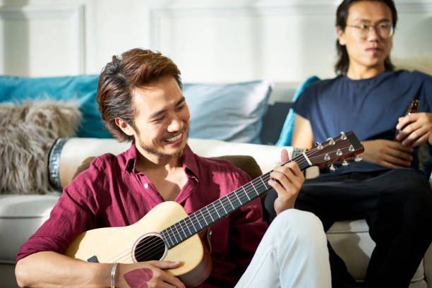 istock young asian musician singing playing guitar 1170807973