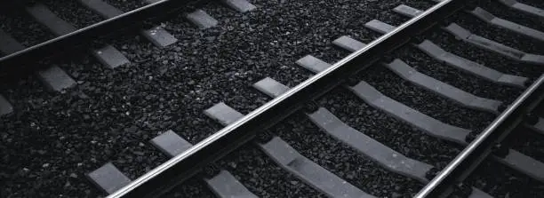 A dark subdued panoramic image of train tracks