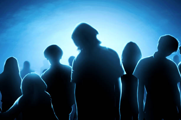 istock Silhouette of zombies crowds at night 1170814723