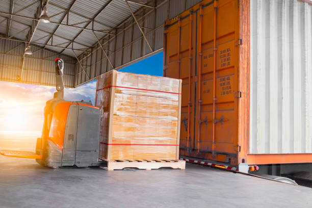 istock electric forklift pallet jack with cargo pallet shipment load into a truck 1170815919