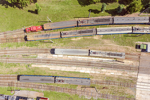 aerial view of a train with locomotive on a railway track. trains at railroad yard at station district