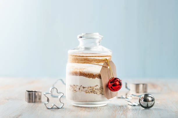 Homemade chip cookie mix Homemade Chocolate chip cookie mix in a glass jar for Christmas holiday gift on wooden background cake jar stock pictures, royalty-free photos & images