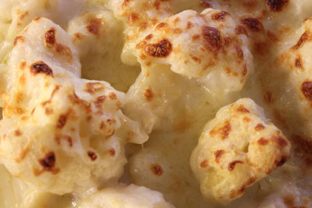 Close-up of baked cauliflower cheese recipe grilled under hot kitchen oven grilled with golden brown melted cheddar cheese for a family dinner, cooked in a cheese sauce, roasted vegetable, brain food healthy eating vegetable as five a day routine Stock photo of baked cauliflower cheese recipe grilled under hot kitchen oven grilled with golden brown melted cheddar cheese for a family dinner, cooked in a cheese sauce, roasted vegetable, brain food healthy eating vegetable as five a day routine melting brain stock pictures, royalty-free photos & images