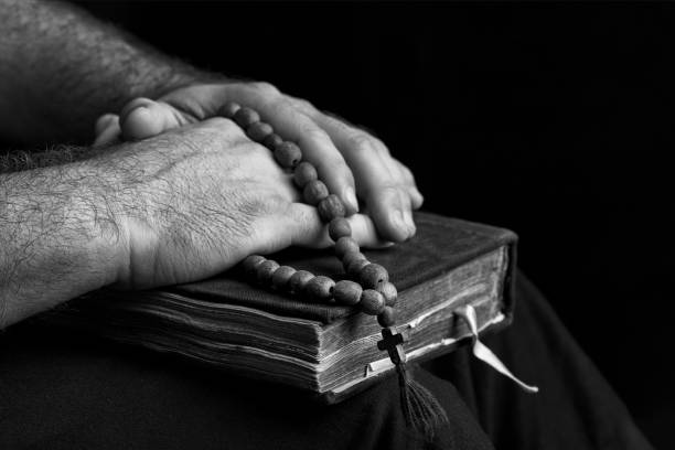 istock Priest with a bible on his knees. 1170823713