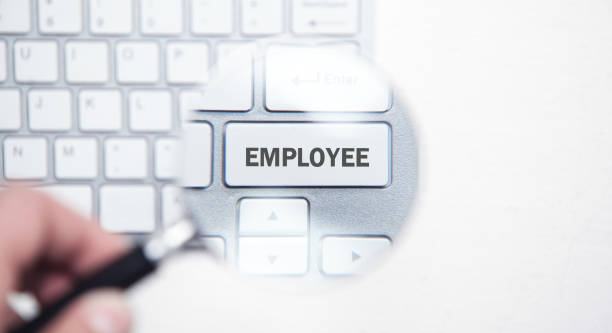 istock Magnifier over keyboard background. Searching new Employee 1170823960