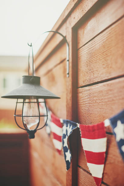 istock American flag background. Flag bunting hanging on fence 1170824551