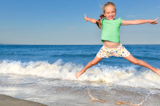 istock Child girl on summer beach. 1170824901