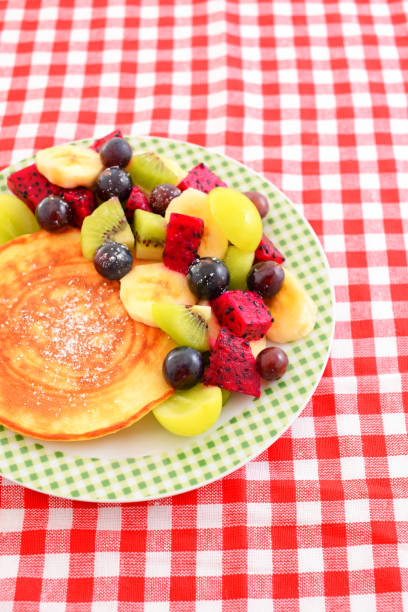 Fresh fruits and fluffy pancakes on the plate