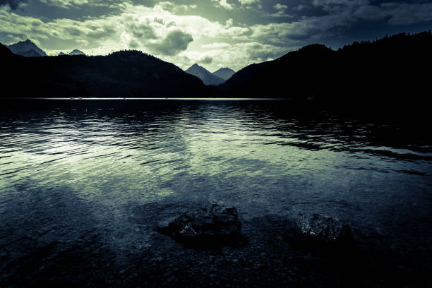 istock Dark moody lake in mountain alpine landscape 1170825828