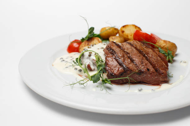 istock beef steak with baked potatoes and vegetables 1170826823