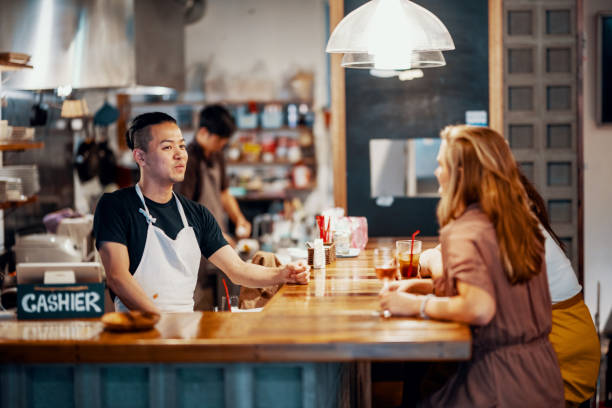 istock Millennial aged friends sitting at a bar talking with the bartender 1170828969