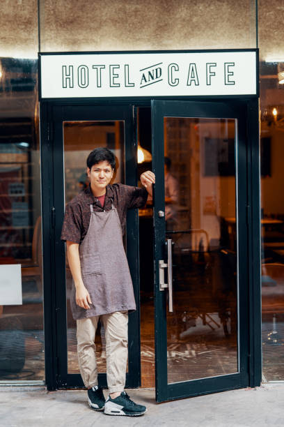 istock Entrepreneur standing in front of his hotel and cafe 1170828980