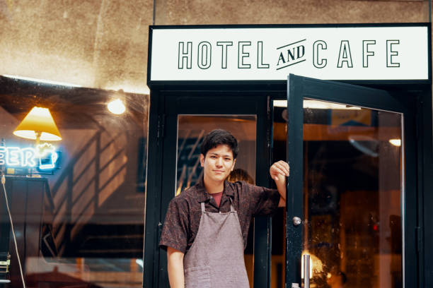 istock Entrepreneur standing in front of his hotel and cafe 1170829058