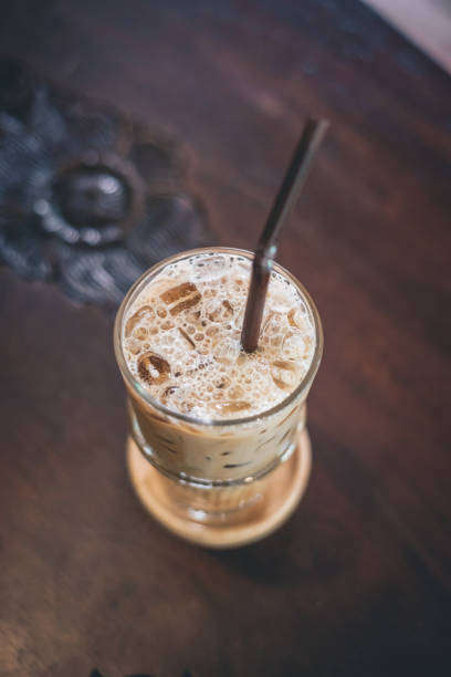 istock ice coffee in glass on wooden table 1170829174