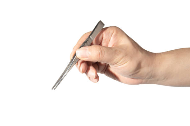 close up of man's hand holding an tweezers. - pinça imagens e fotografias de stock