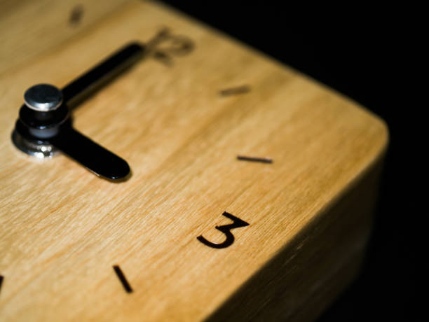 istock Close up wooden clock at three o'clock. 1170835385