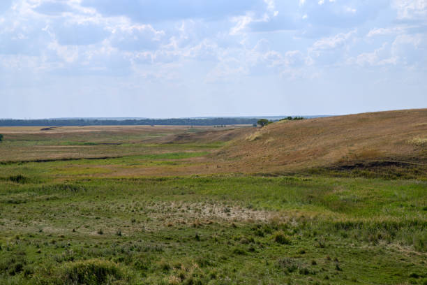 istock Russian steppe with ravines under rays of hot sun 1170838621