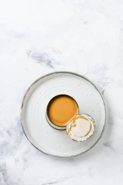 istock Condensed or evaporated milk in open tin on light concrete table. Top view. 1170839880
