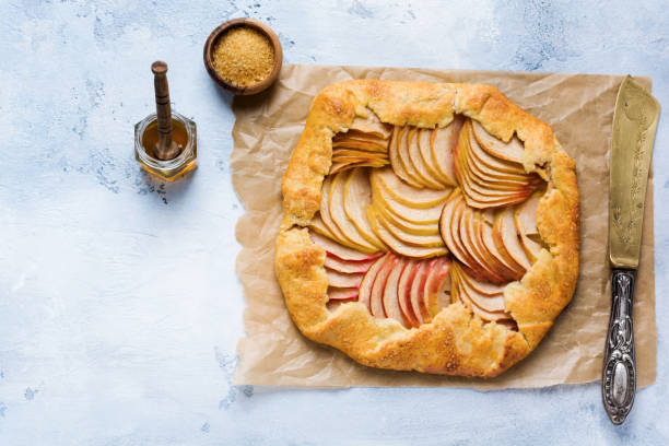 istock Apple galette, pie, cake with honey and cane sugar on light concrete background. Copy space. Top view 1170840221