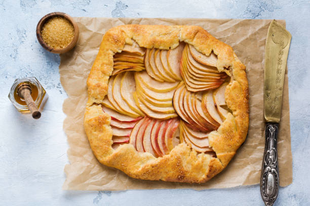 istock Apple galette, pie, cake with honey and cane sugar on light concrete background. Copy space. Top view 1170840295