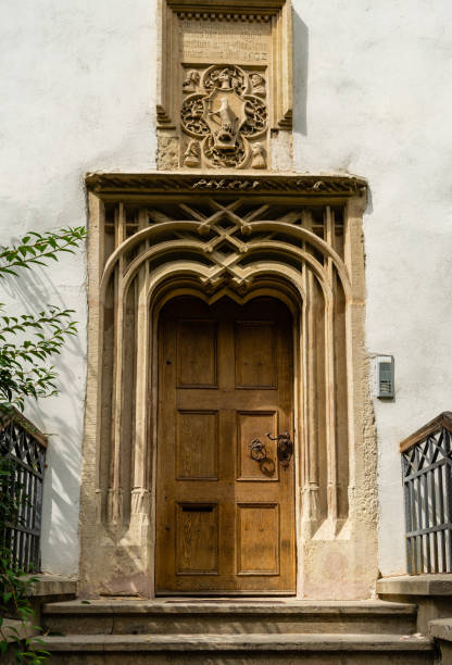 istock Old door with metal knocker in circular shape. 1170848124