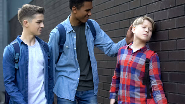 istock Cruel students bullying boy in backyard, punching head, physical intimidation 1170848347