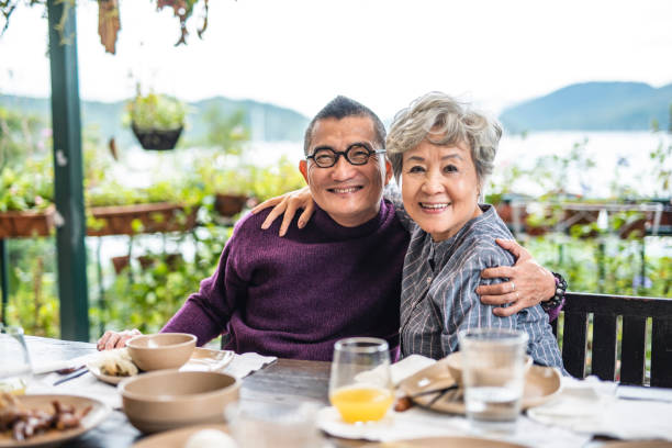 istock Chinese Seniors Embracing and Looking at Camera After Lunch 1170850264