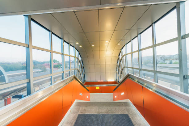 istock Modern corridor with staircase surrounded by glass windows 1170850954