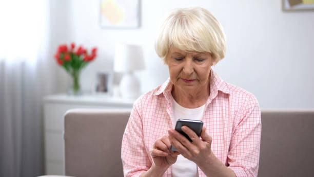 istock Serious elderly woman learning using new smartphone, technology for old people 1170852811