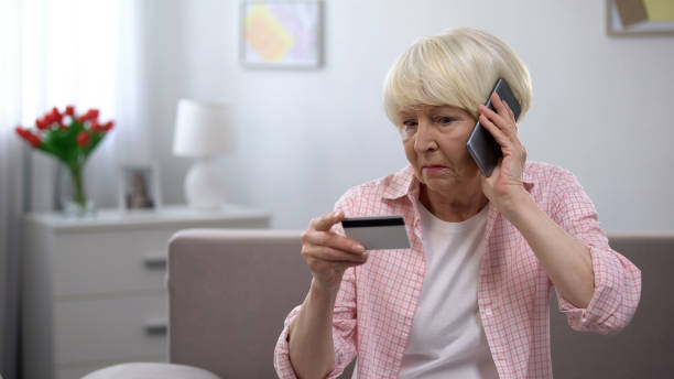 istock Aged woman calling children asking for help with using banking card, generation 1170852848