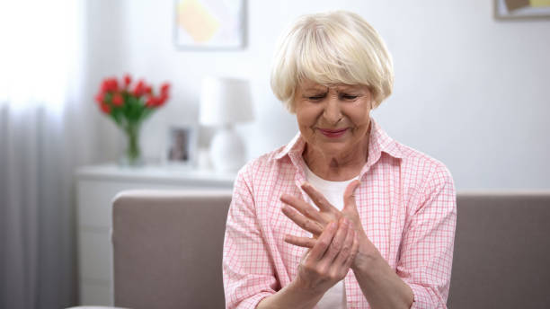 Upset old woman suddenly feeling sharp pain in wrist, arthritis health problem Upset old woman suddenly feeling sharp pain in wrist, arthritis health problem rheumatoid arthritis stock pictures, royalty-free photos & images