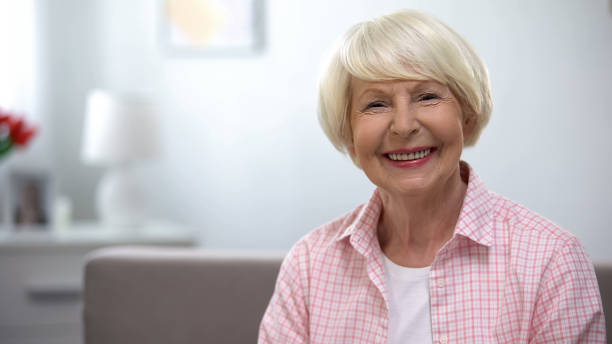 istock Happy elderly woman smiling at camera, social security, retirement benefits 1170853095
