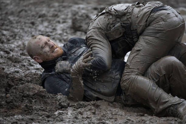 istock Krav Maga military muddy fighting duo 1170853272