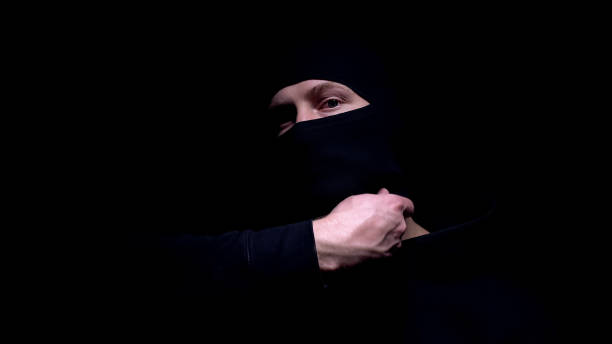 istock Man taking off balaclava and angrily looking into camera, thief or thug, closeup 1170853661
