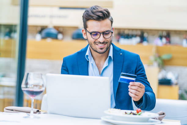istock Businessman using credit card in restaurant 1170859114